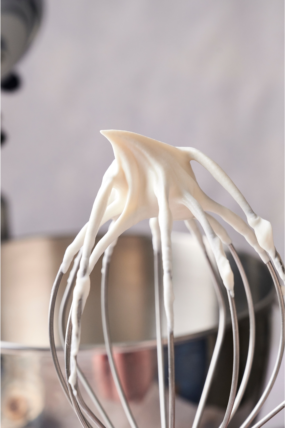 A whisk with stiff creme fraiche frosting.
