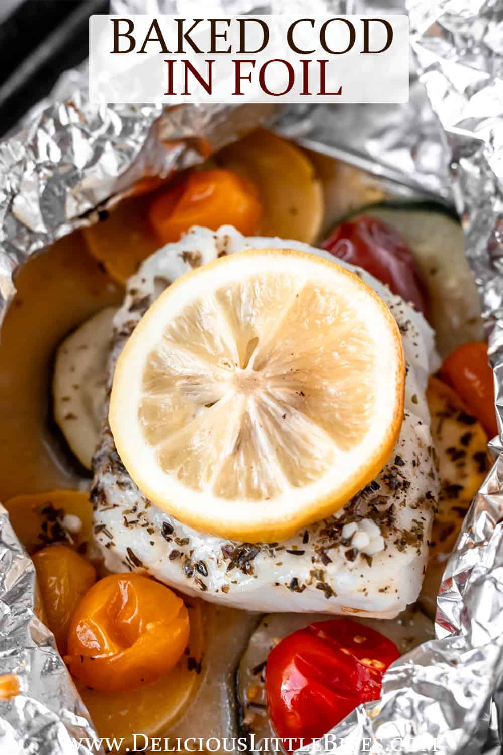 Baked cod and vegetables topped with lemon in foil with text overlay.