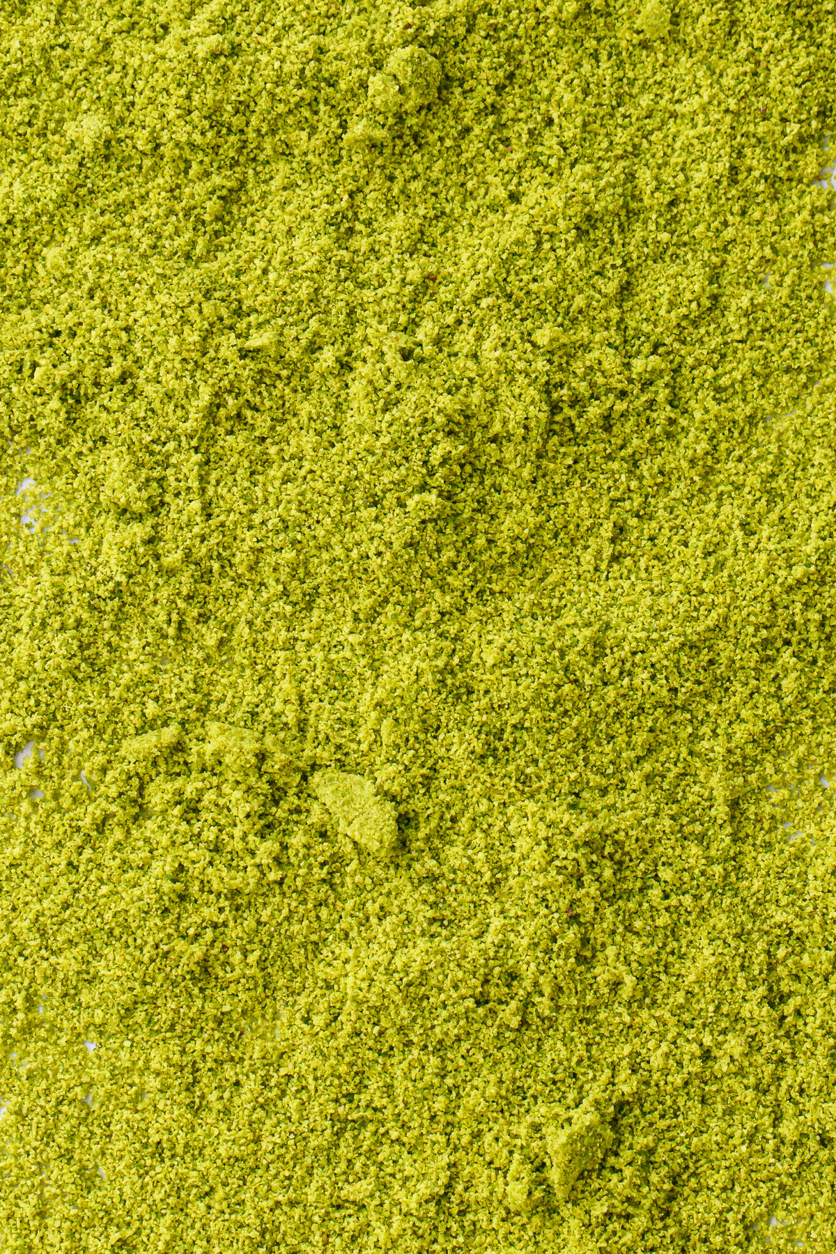 Closeup showing the fine clumps of of pistachio flour texture.
