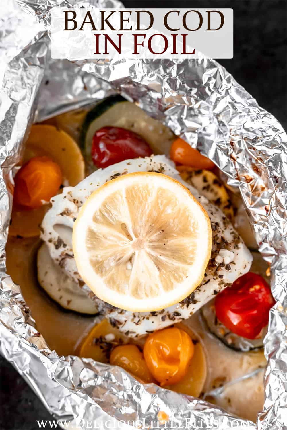 Baked cod and vegetables topped with lemon in foil with text overlay.