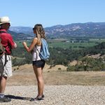 two hikers enjoy sonoma county mountain views at jordan winery in healdsburg