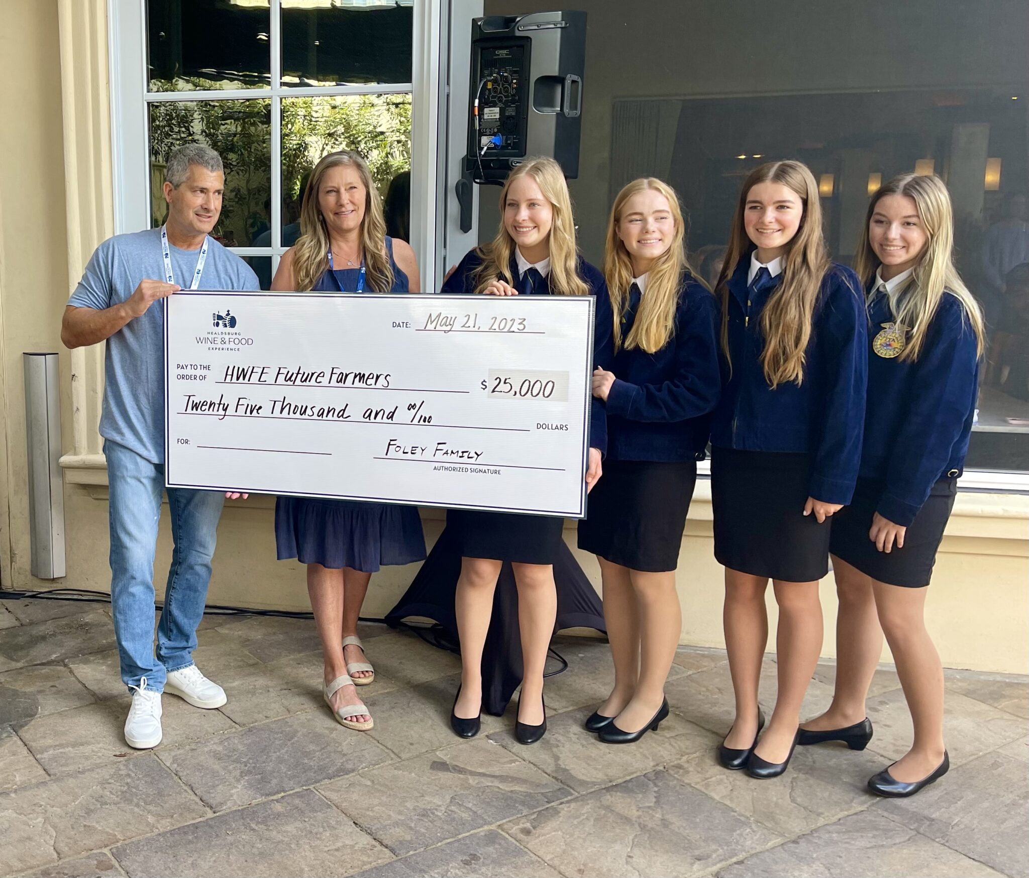 A giant check being presented to representatives of the FFA charity. 