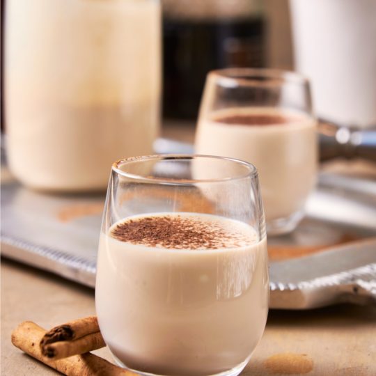 A glass with bourbon cream topped with cinnamon.