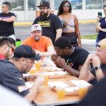 a group of people sitting around a table eating food