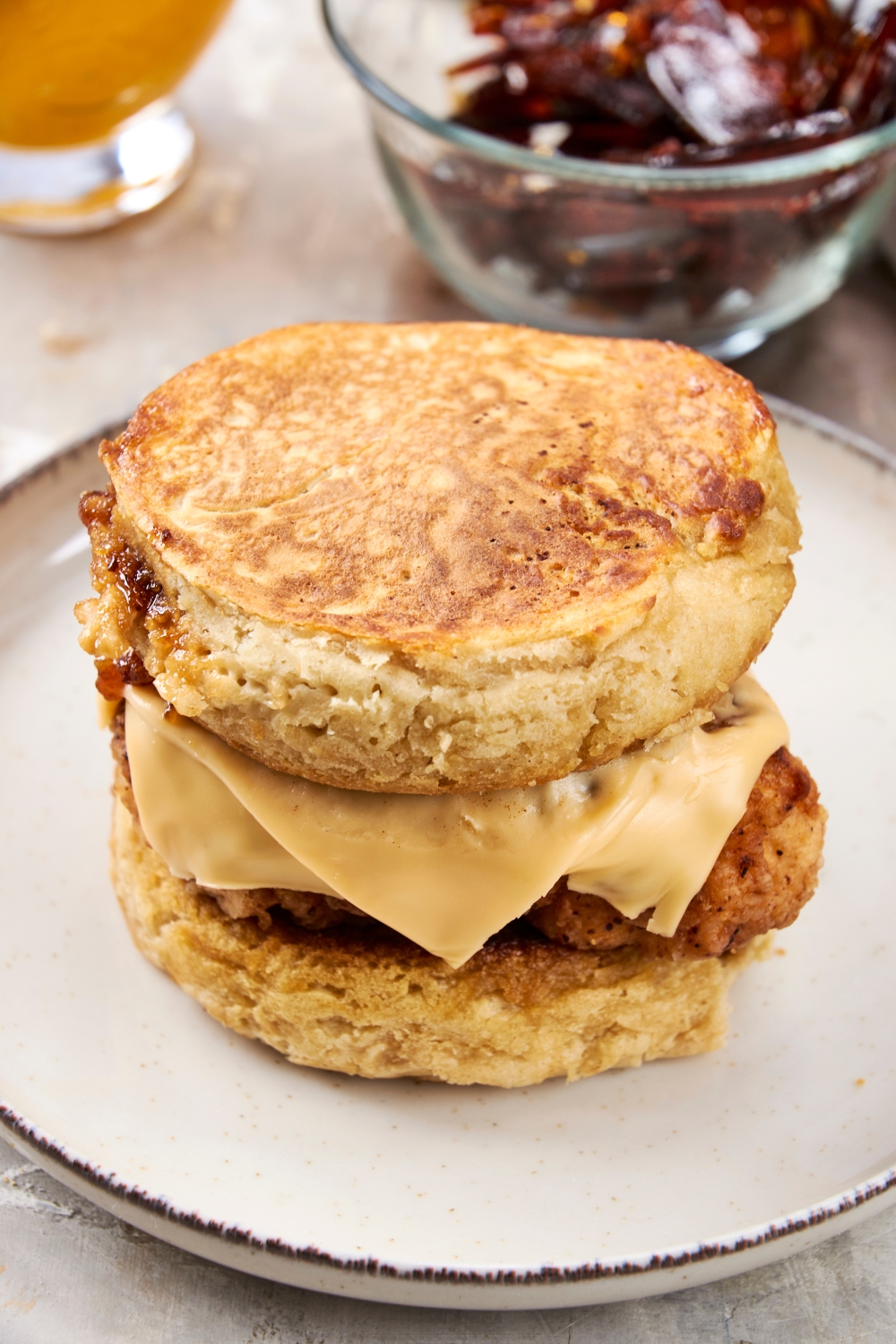 A crispy fried piece of chicken is sandwiched between two perfectly cooked hot cakes.